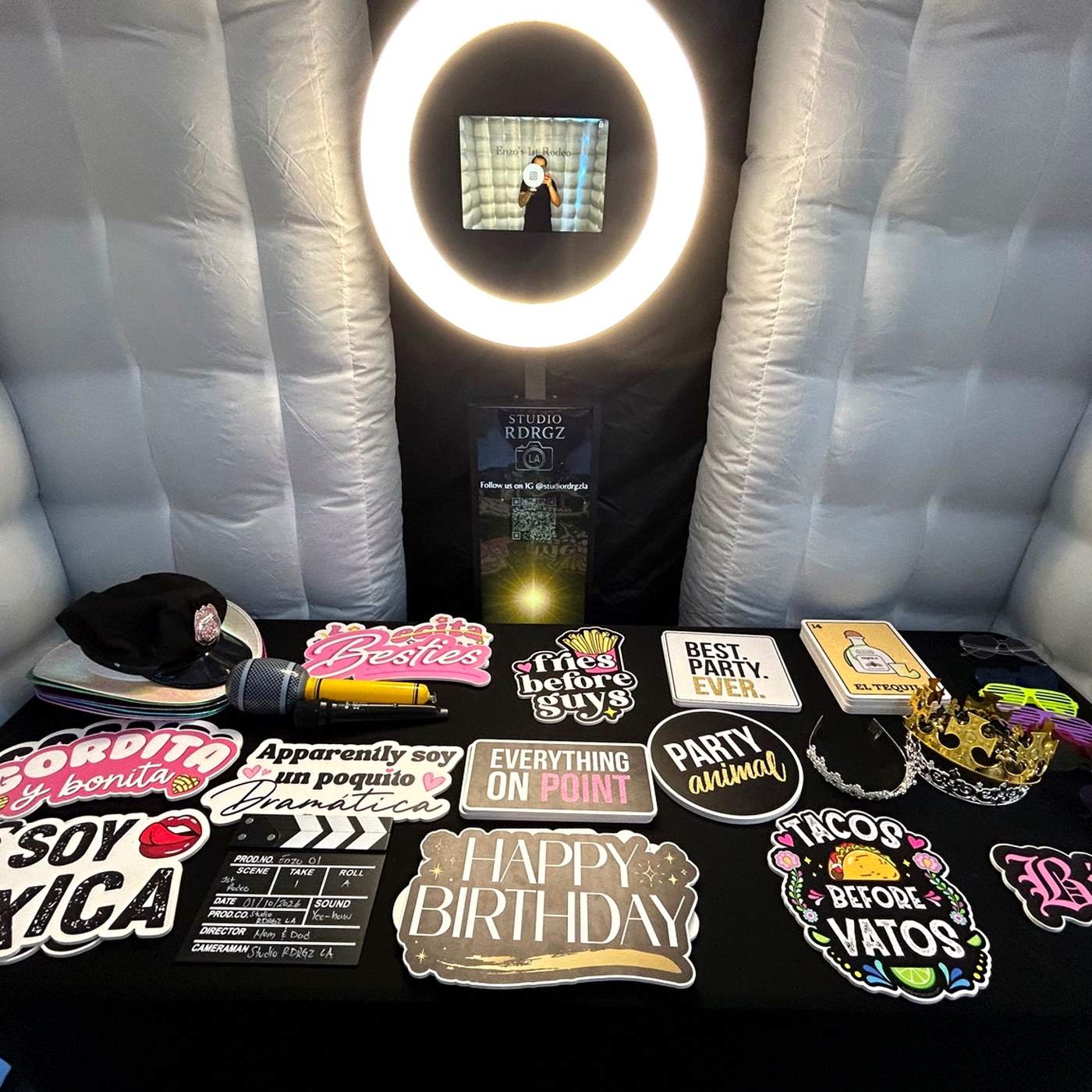 Inside the photo booth with ring light and curated prop table