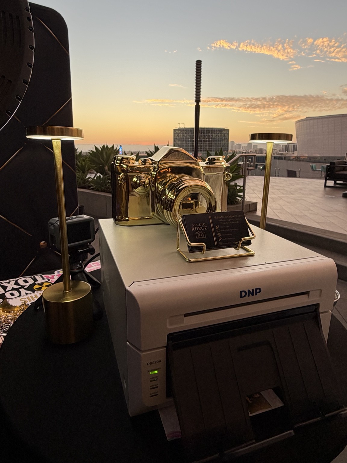 Printer and gold camera display at sunset