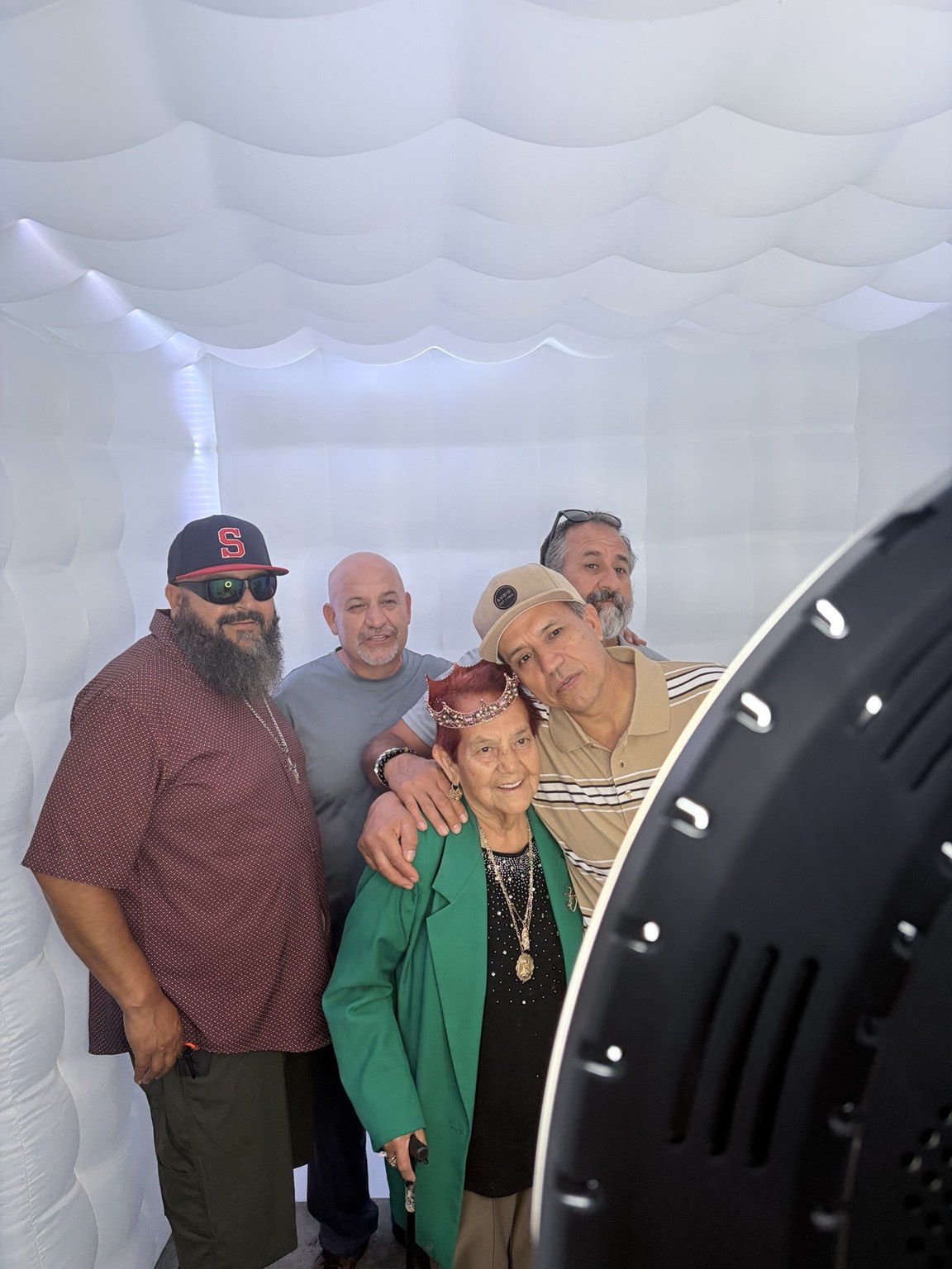 Mateo Benjamin's Baptism guests posing inside the white inflatable booth by Studio RDRGZ LA