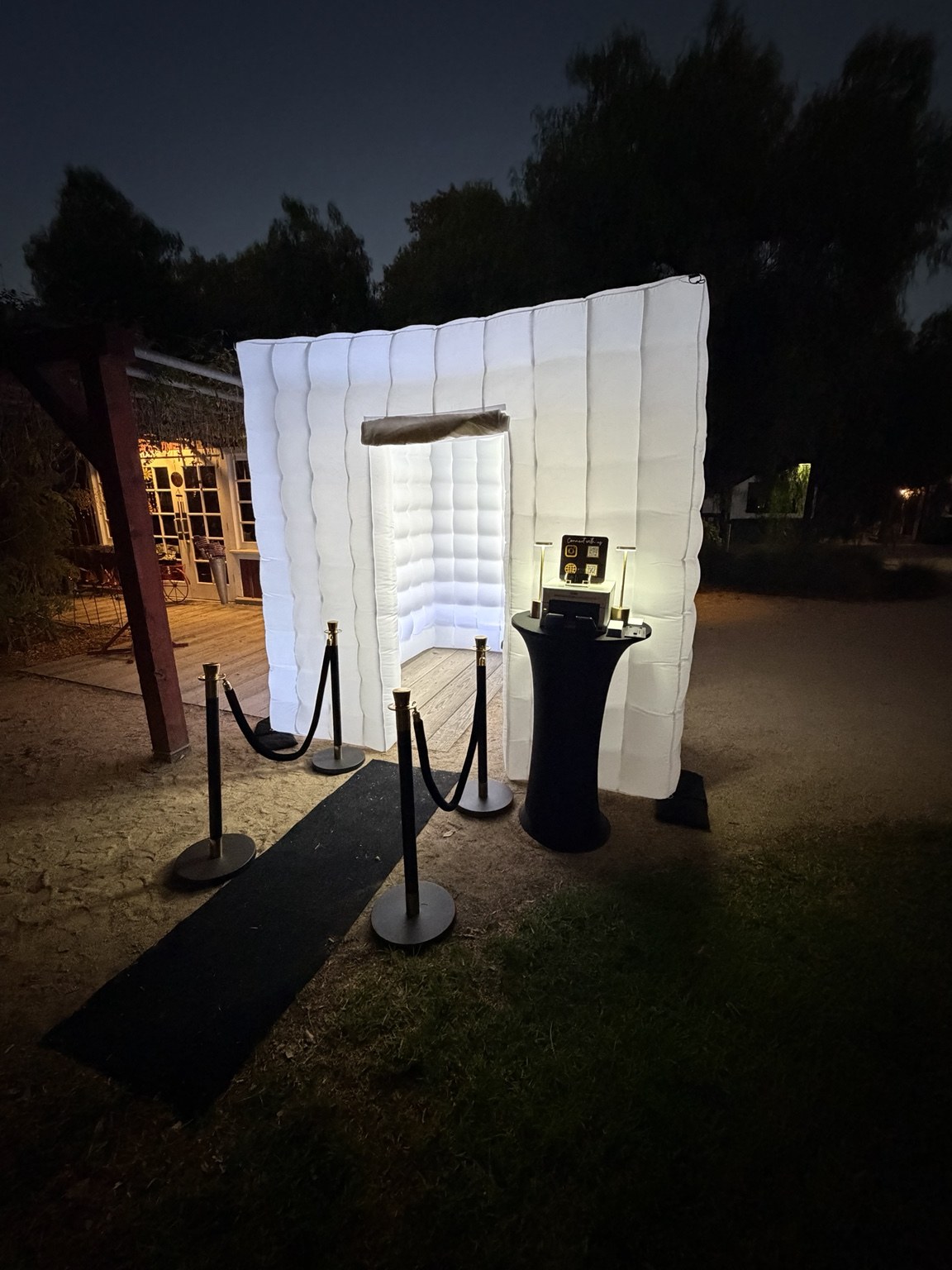 The Alcalas wedding illuminated white inflatable photo booth setup at night